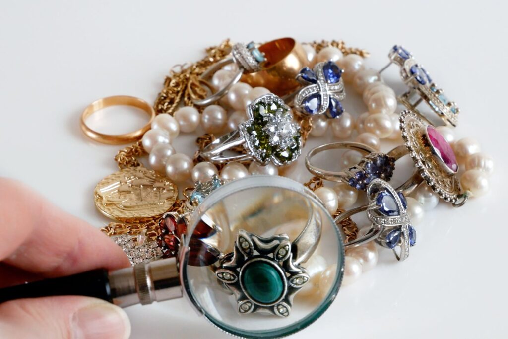 Checking gold and silver jewellery with a magnifying glass