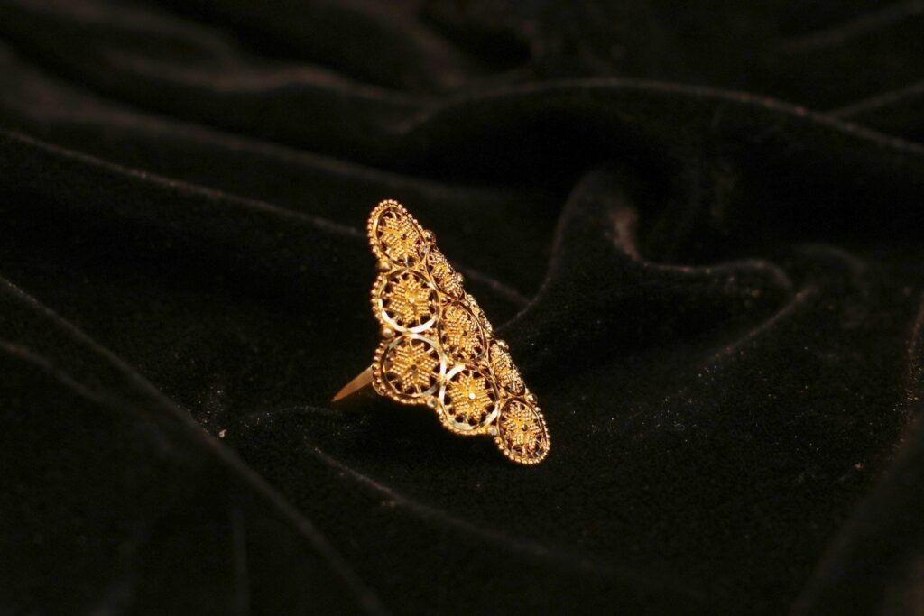 An ornate gold filigree ring