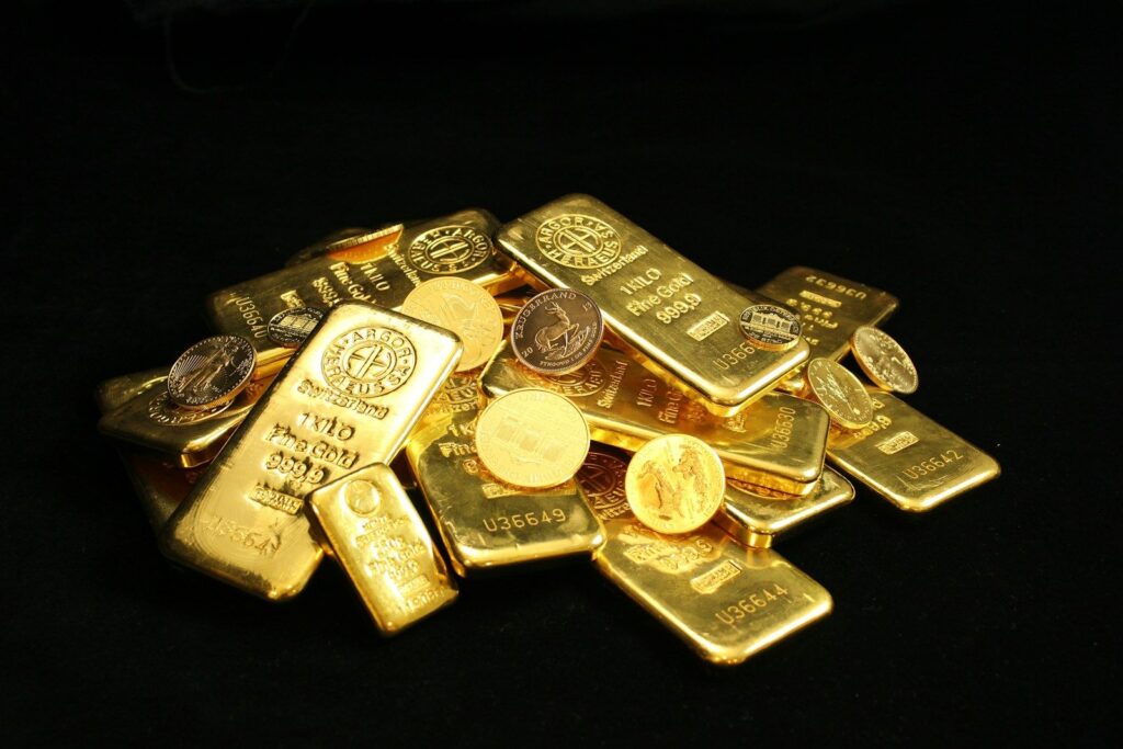 Gold bars and coins on a black background
