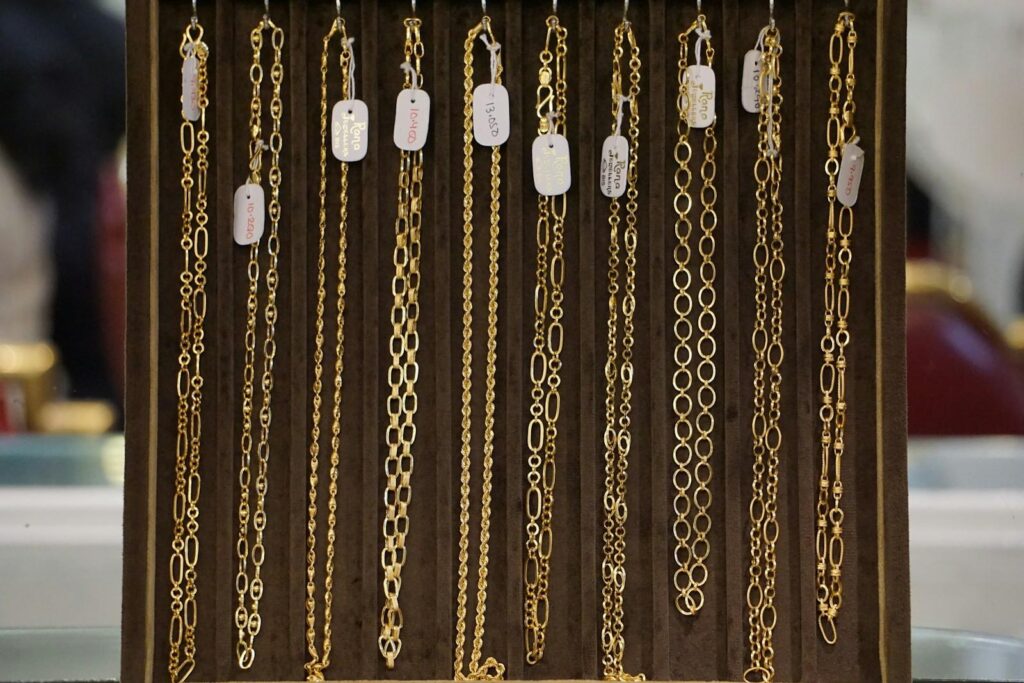 Gold chains hanging on a display
