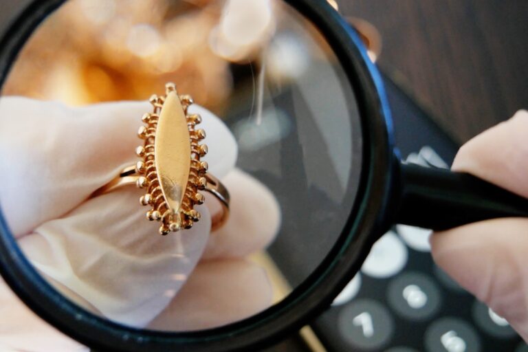 Gold hallmark on a ring under a magnifying glass