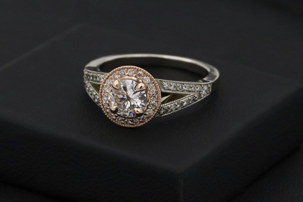 A halo diamond ring on a black box