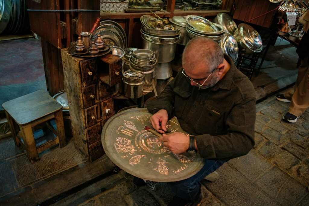 Craftsman hand engraving metal