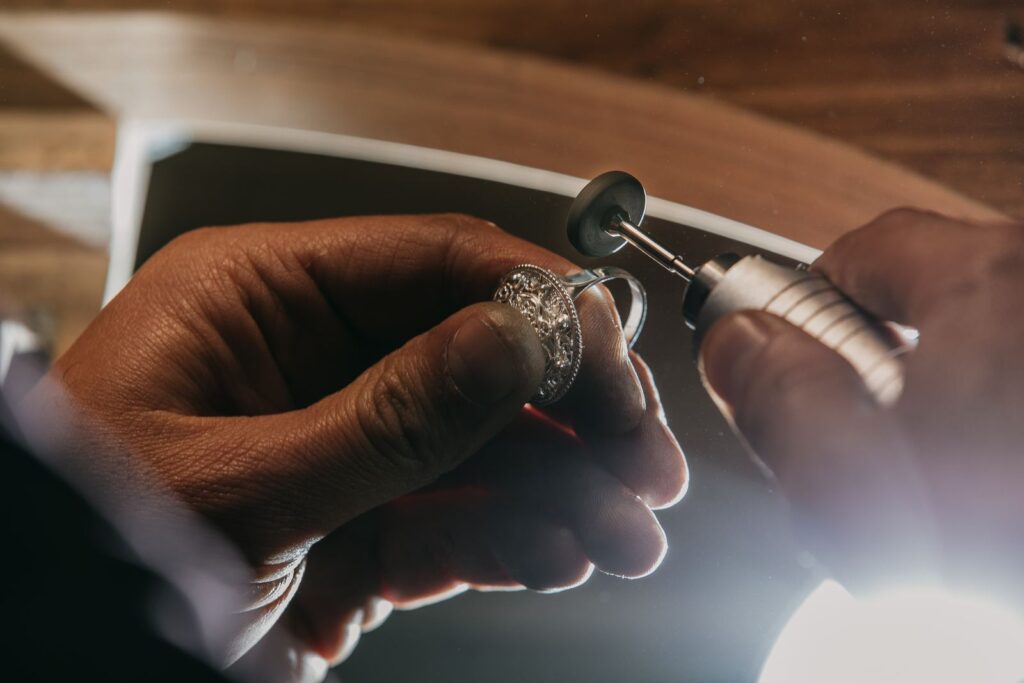 Jeweller finishing a ring band with a rotary tool