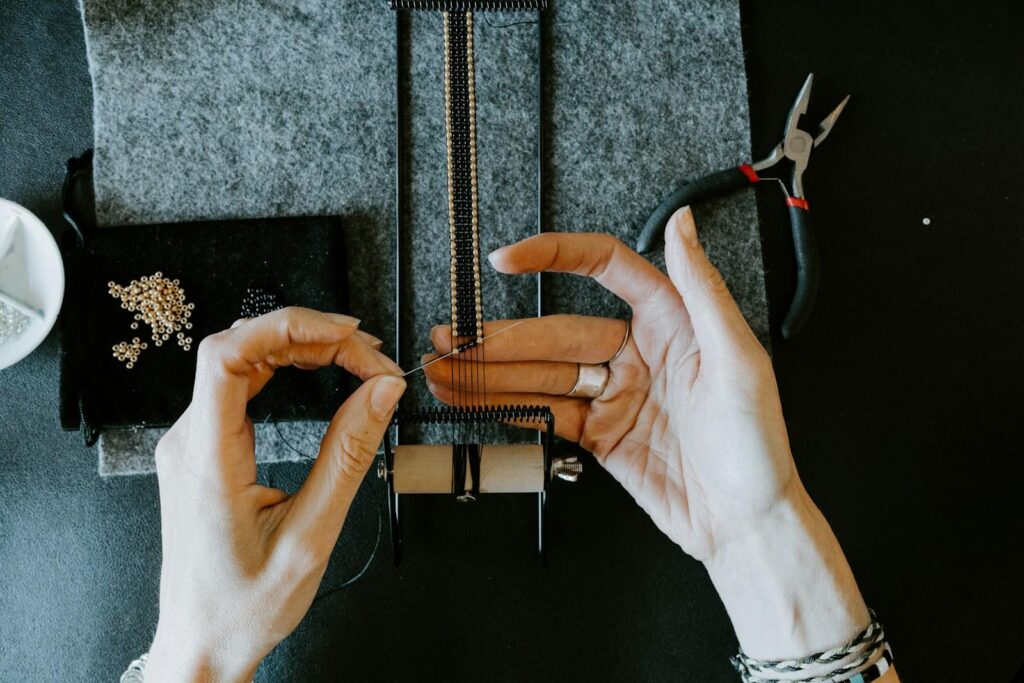 Jeweller’s hands working on small jewellery parts