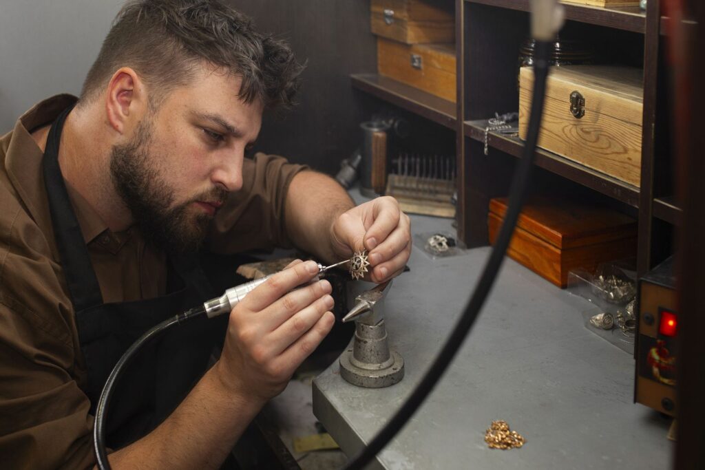 Jeweller working carefully on a ring at the workbench