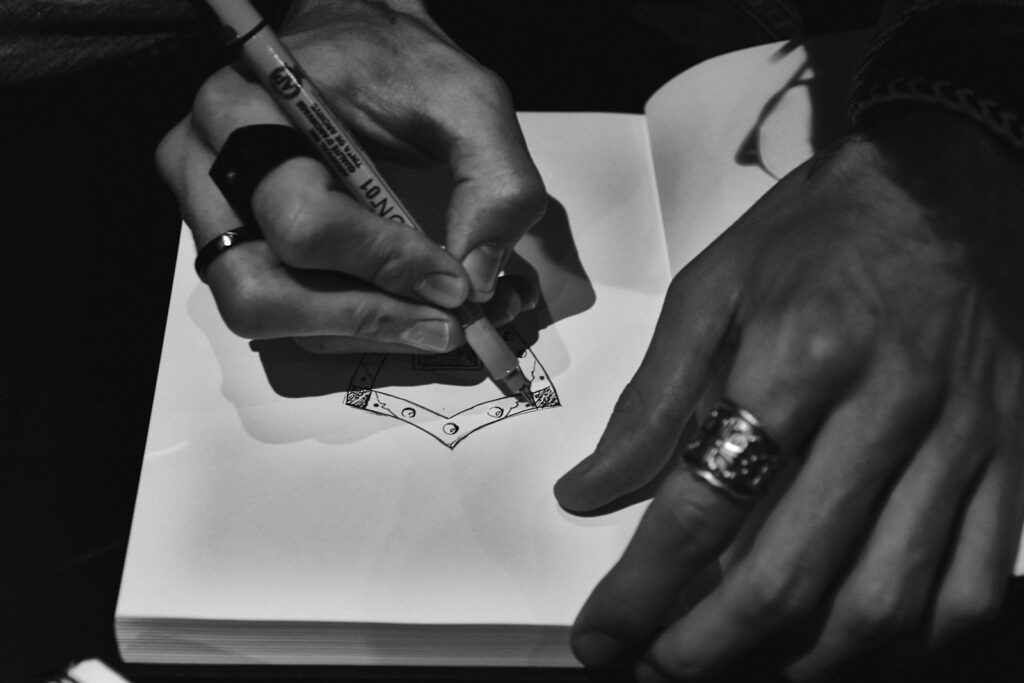 Hands sketching a jewellery design