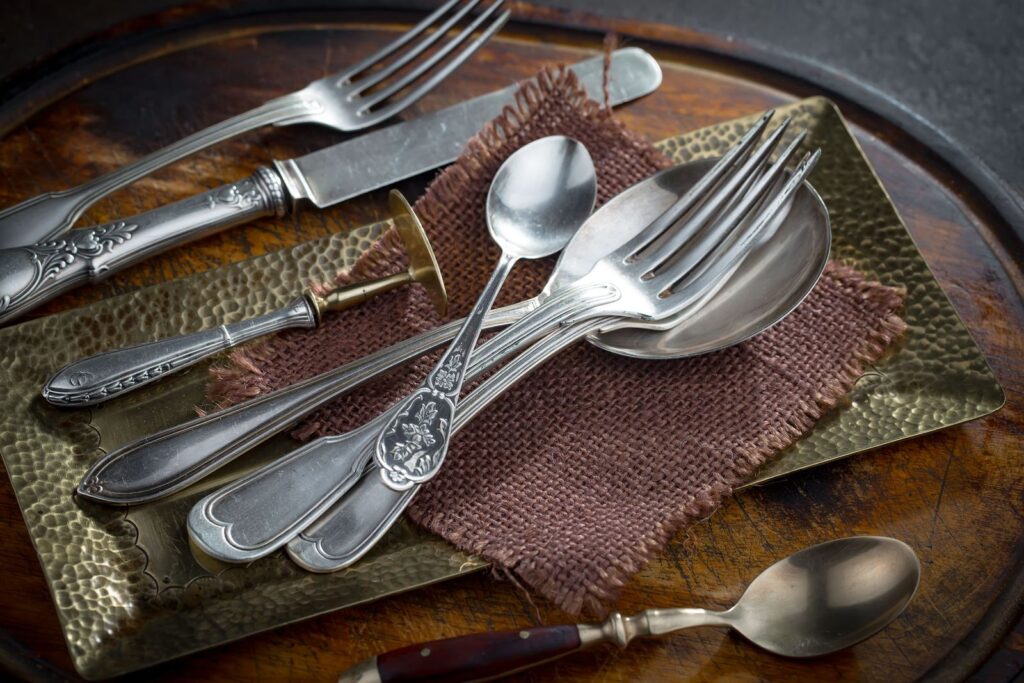 Old silver cutlery and dishes on a table
