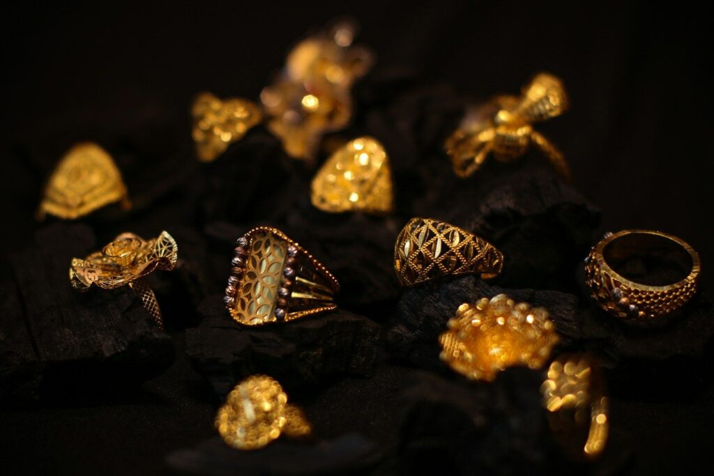 Ornate gold rings on a dark background