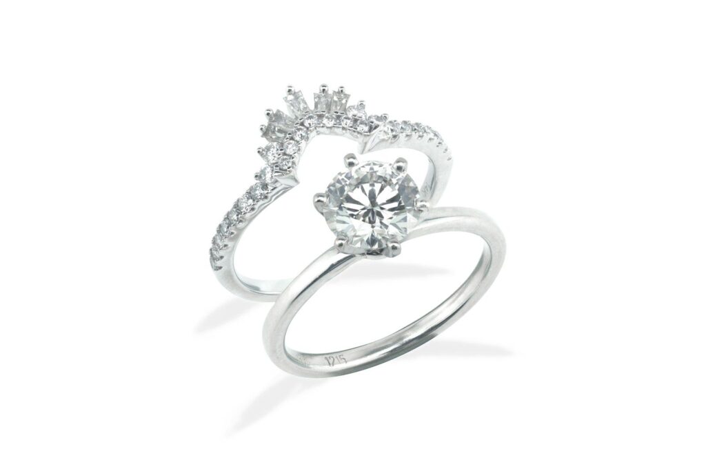 A white metal engagement ring and band set with diamonds