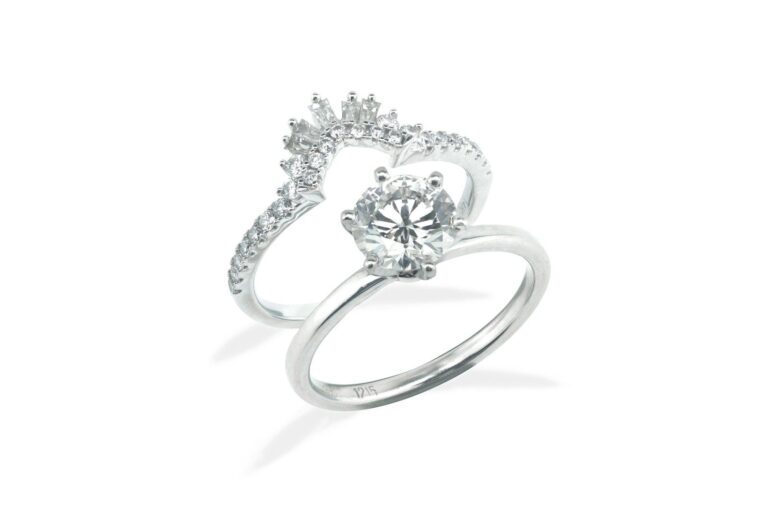 A white metal engagement ring and band set with diamonds