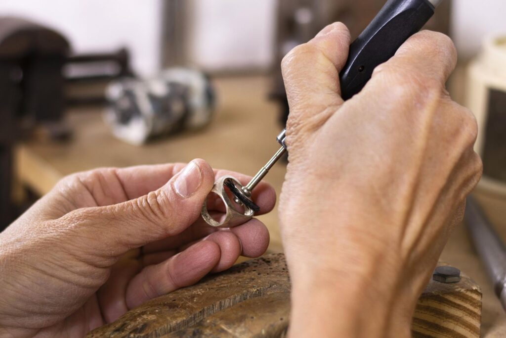 Jeweller polishing a ring after resizing