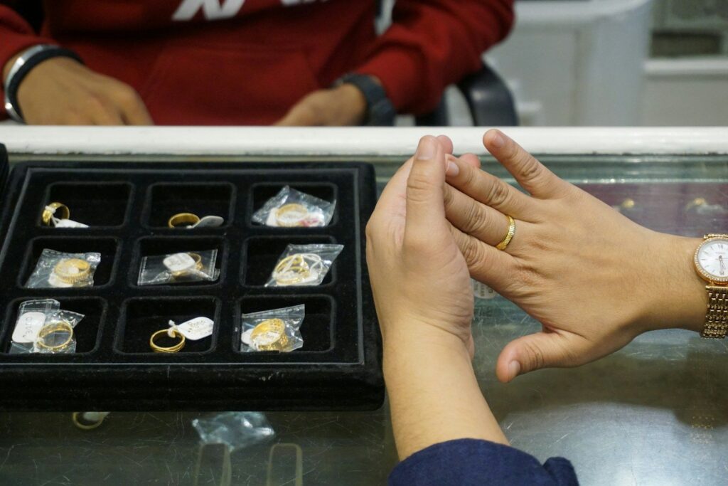 A customer trying on a ring at a jewellery counter