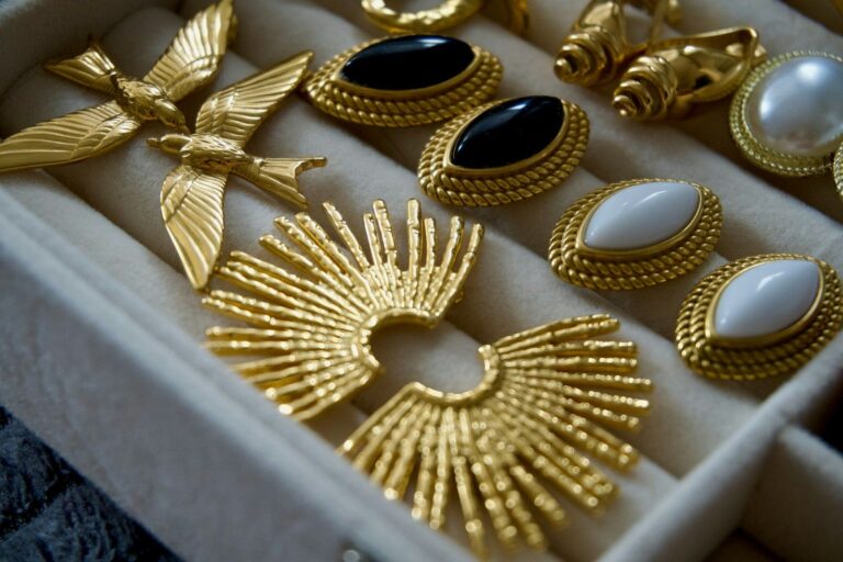 A collection of vintage gold earrings with stones and pearls