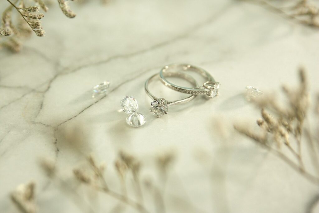 White metal rings resting on marble