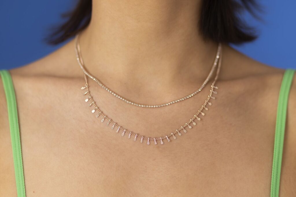 Woman wearing delicate layered gold necklaces